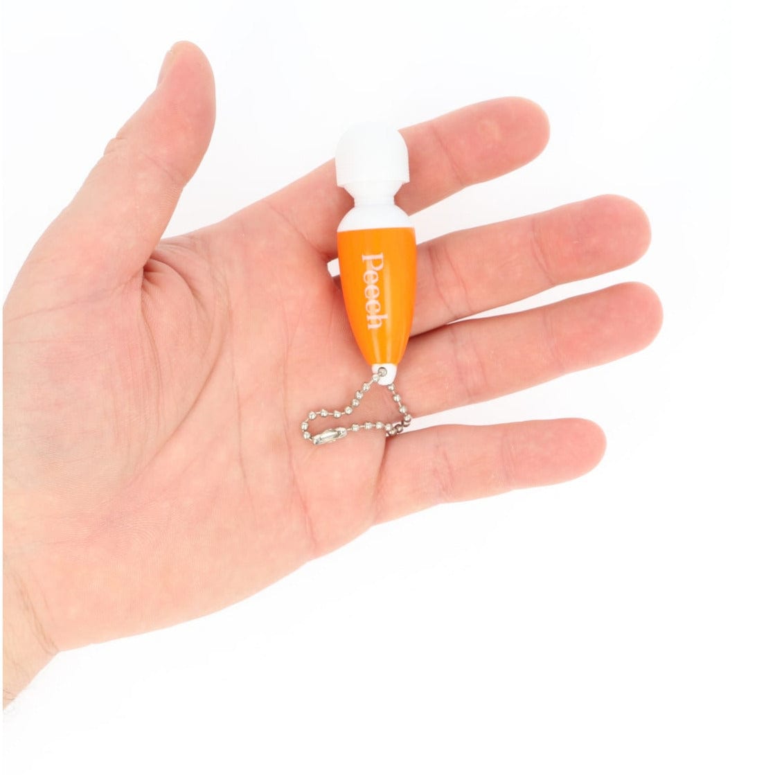 Orange mini vibrerende nøglering fra Peech i hånd